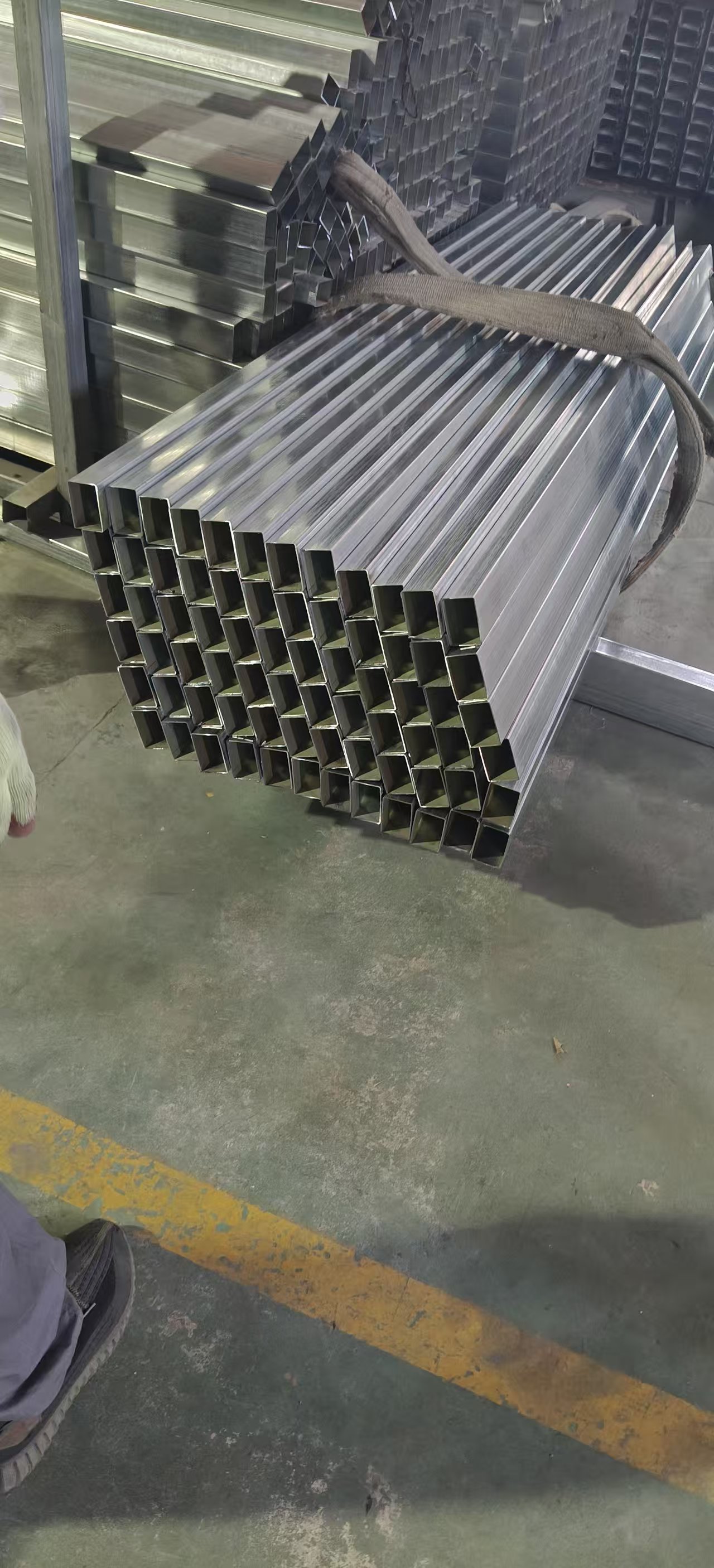 Stacked aluminium square profiles in factory